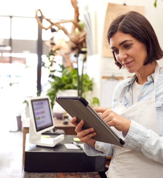 Female,Owner,With,Digital,Tablet,Standing,Behind,Sales,Desk,Of